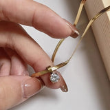 Golden Plated Stainless Steel Necklace with Sparkling Synthetic Cubic Zirconia Pendantd